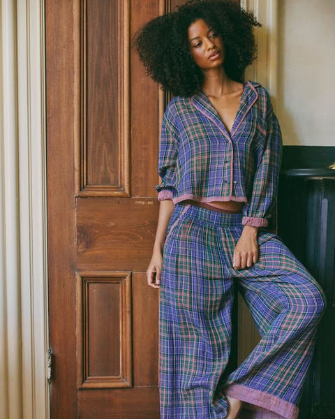 A woman in plaid matching pajama set.