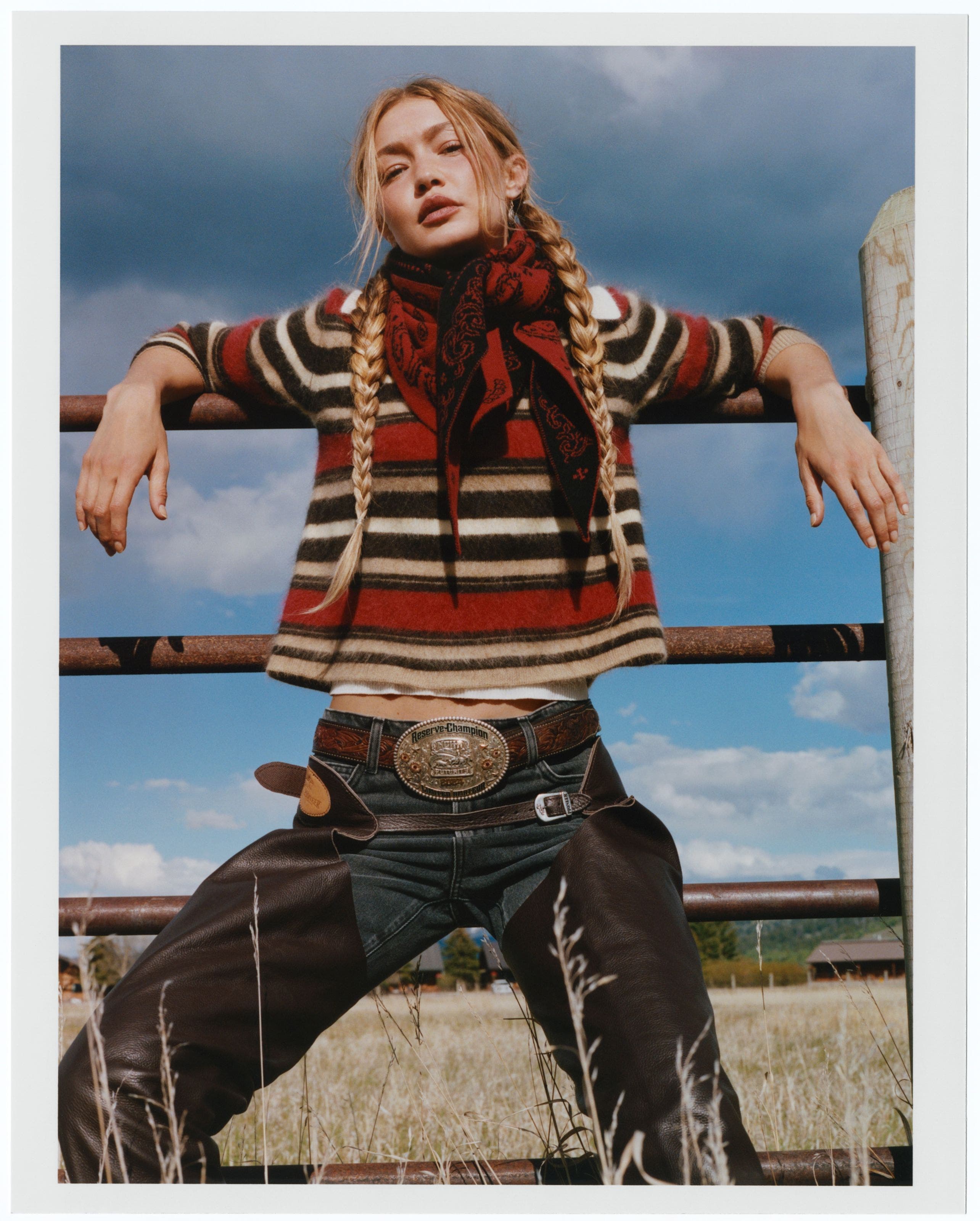 Gigi Hadid wearing a striped sweater, dark wash jeans, and a red bandana.
