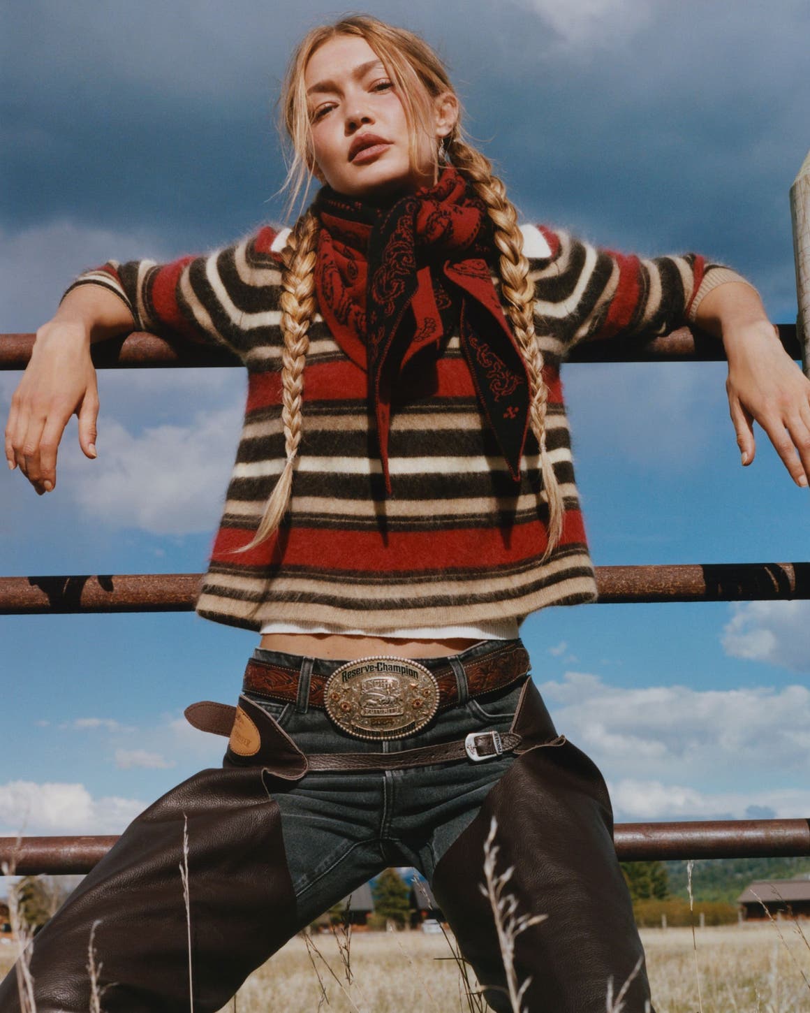 Gigi Hadid wearing a striped sweater, dark wash jeans, and a red bandana.