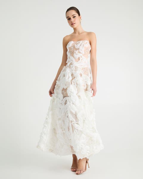 A woman in white strapless floral wedding gown.