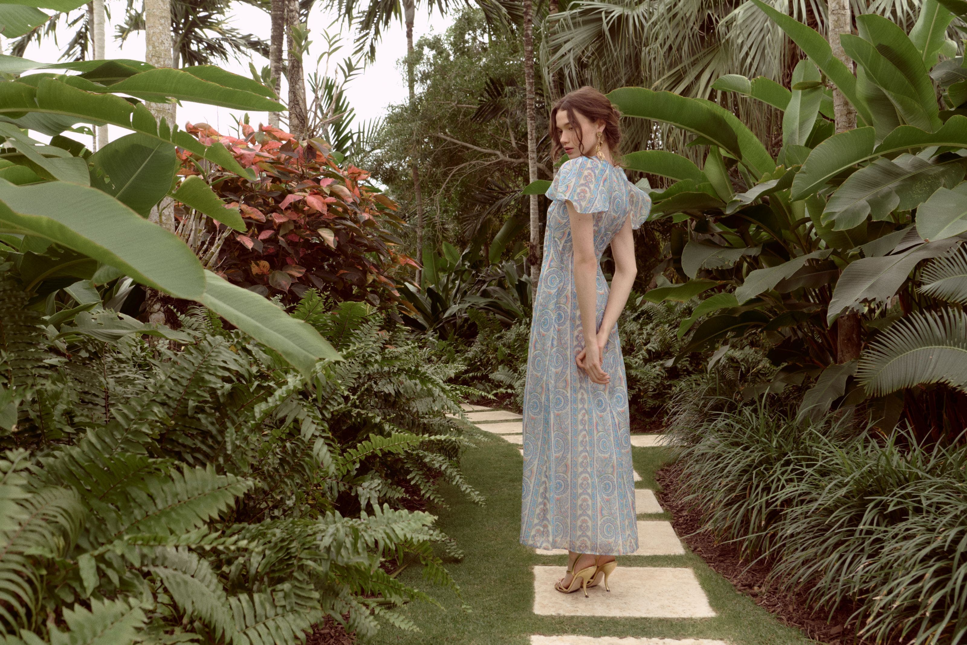 Woman wearing a printed gown from Hill House Home.