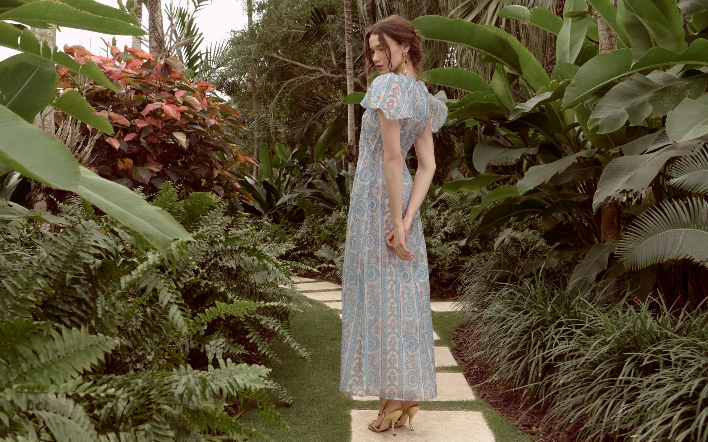 Woman wearing a printed gown from Hill House Home.