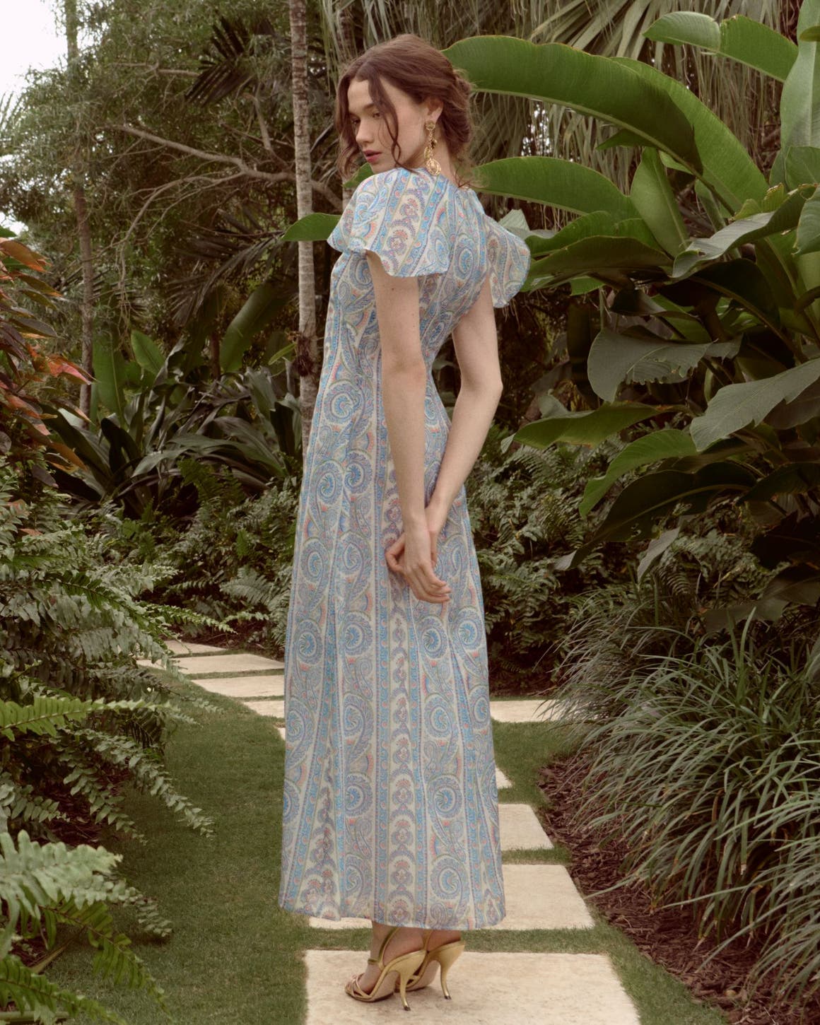 Woman wearing a printed gown from Hill House Home.