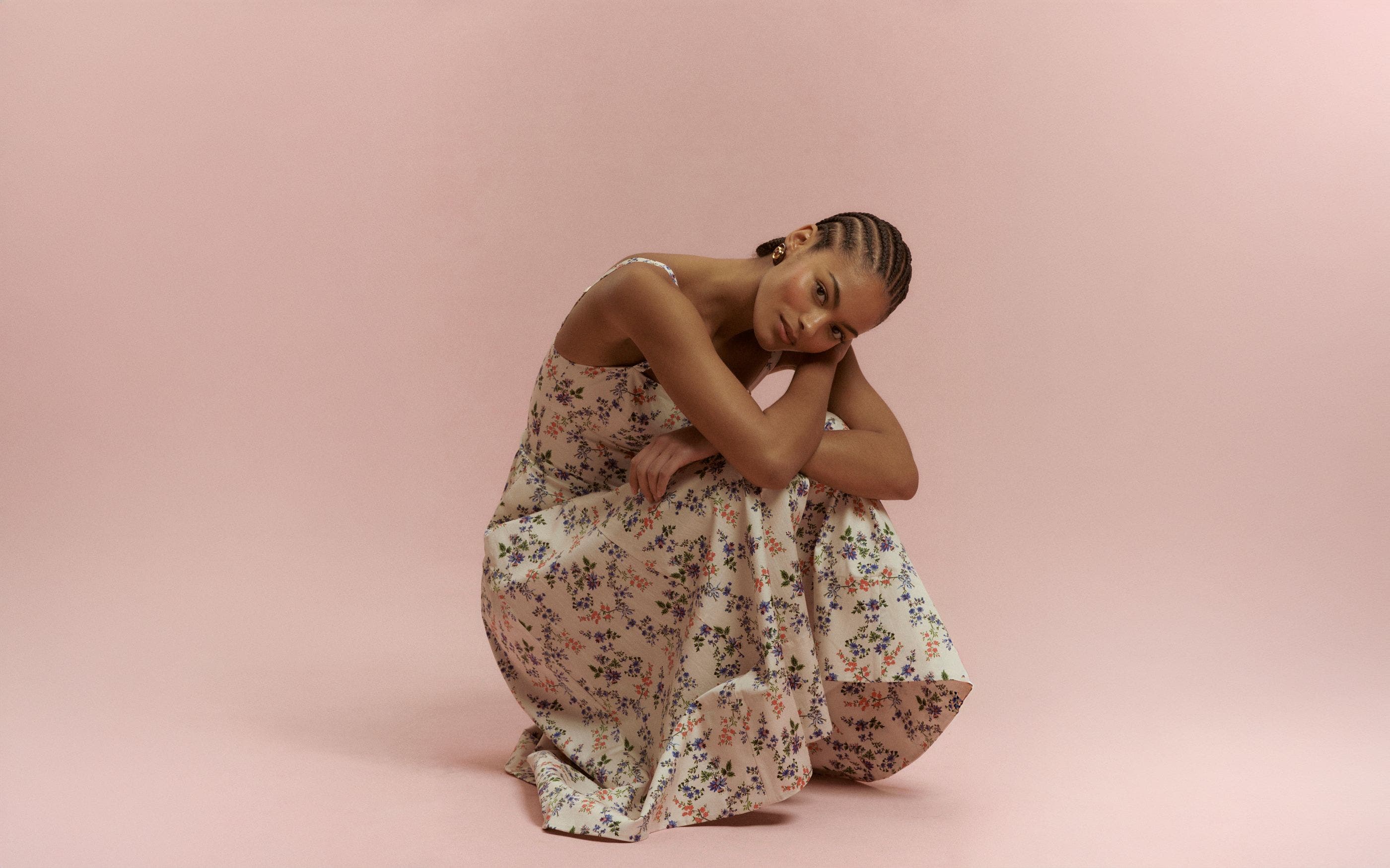 Woman wearing a floral dress from Hill House Home.