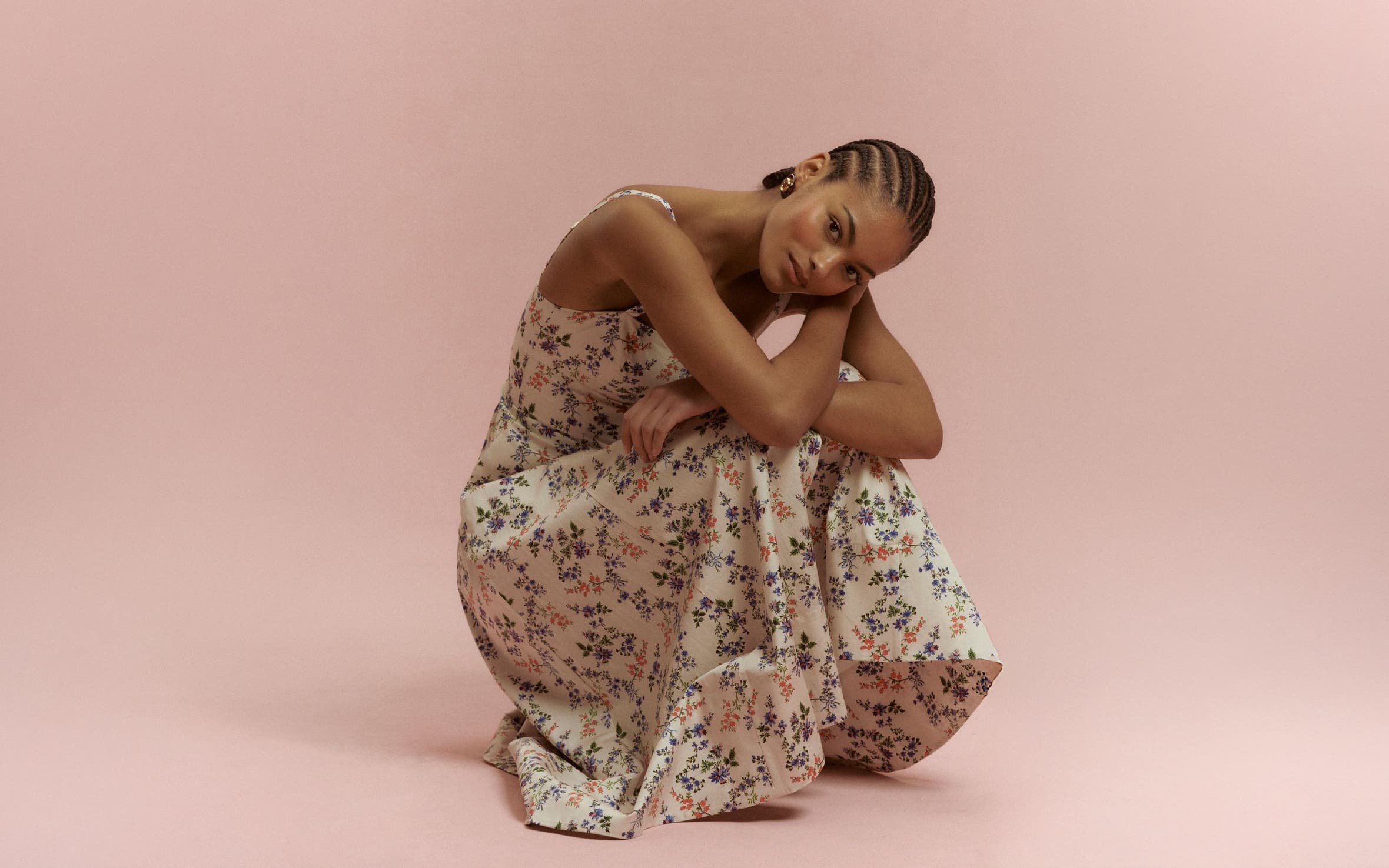 Woman wearing a floral dress from Hill House Home.