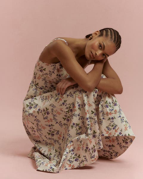 Woman wearing a floral dress from Hill House Home.
