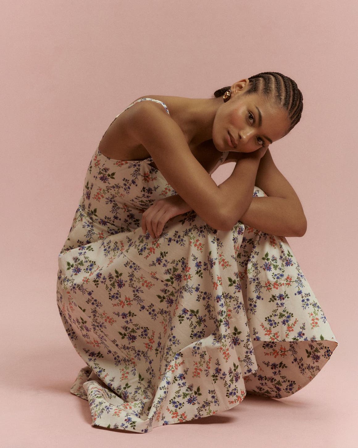 Woman wearing a floral dress from Hill House Home.