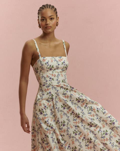 A woman wearing a floral maxi dress.