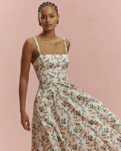 A woman wearing a floral maxi dress.