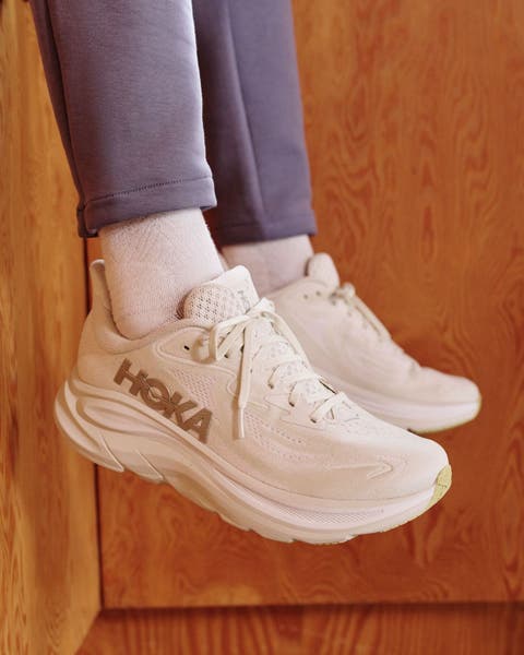 Man wearing white Hoka shoes