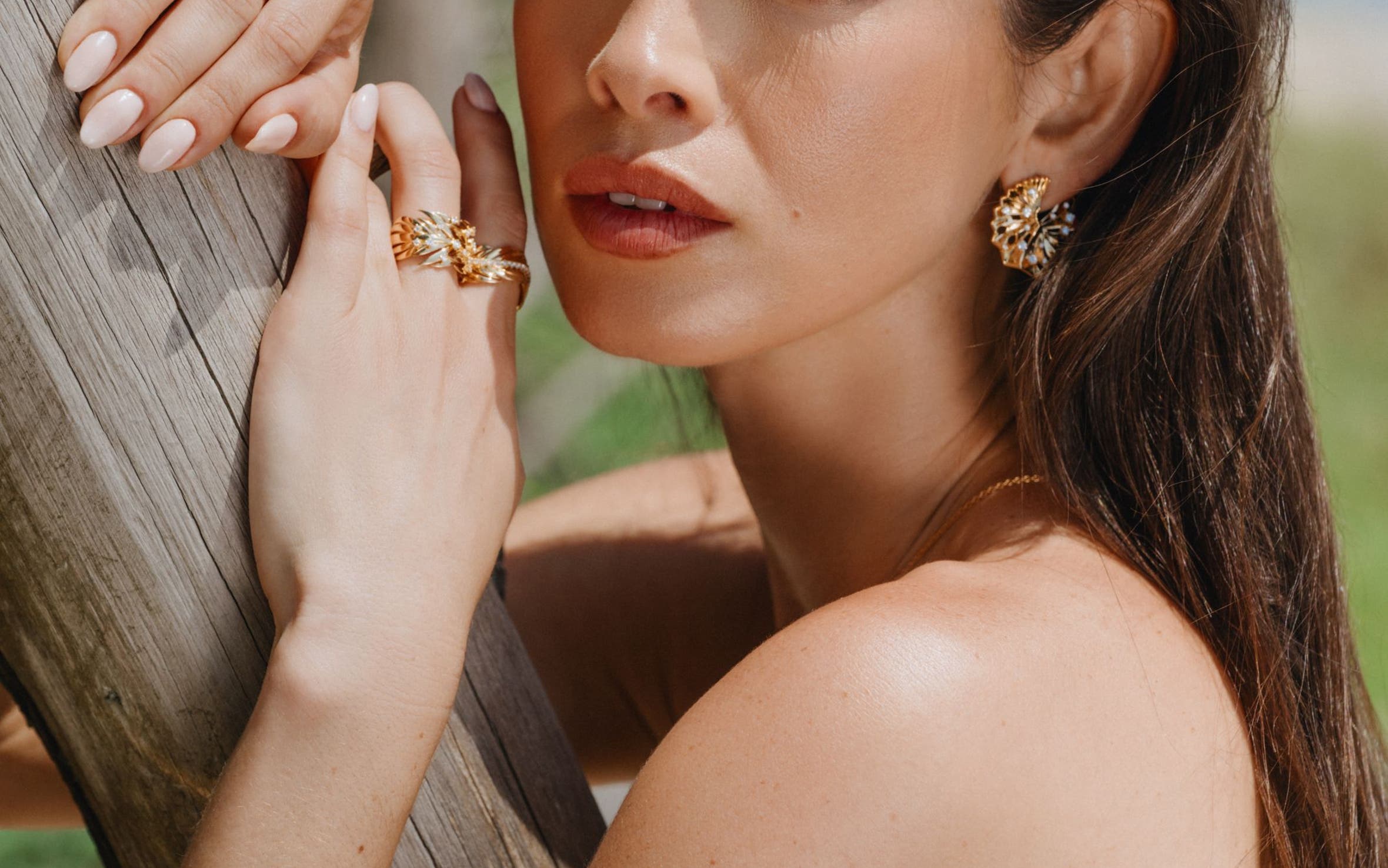 A woman wearing Hueb earrings, rings and bracelet.