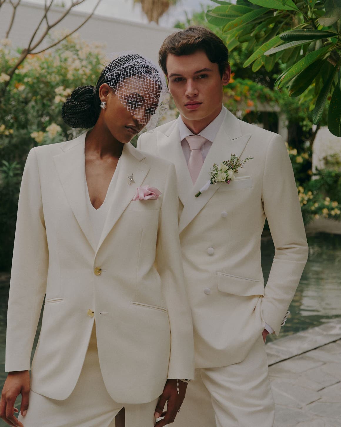 A woman and man wearing white suits. 