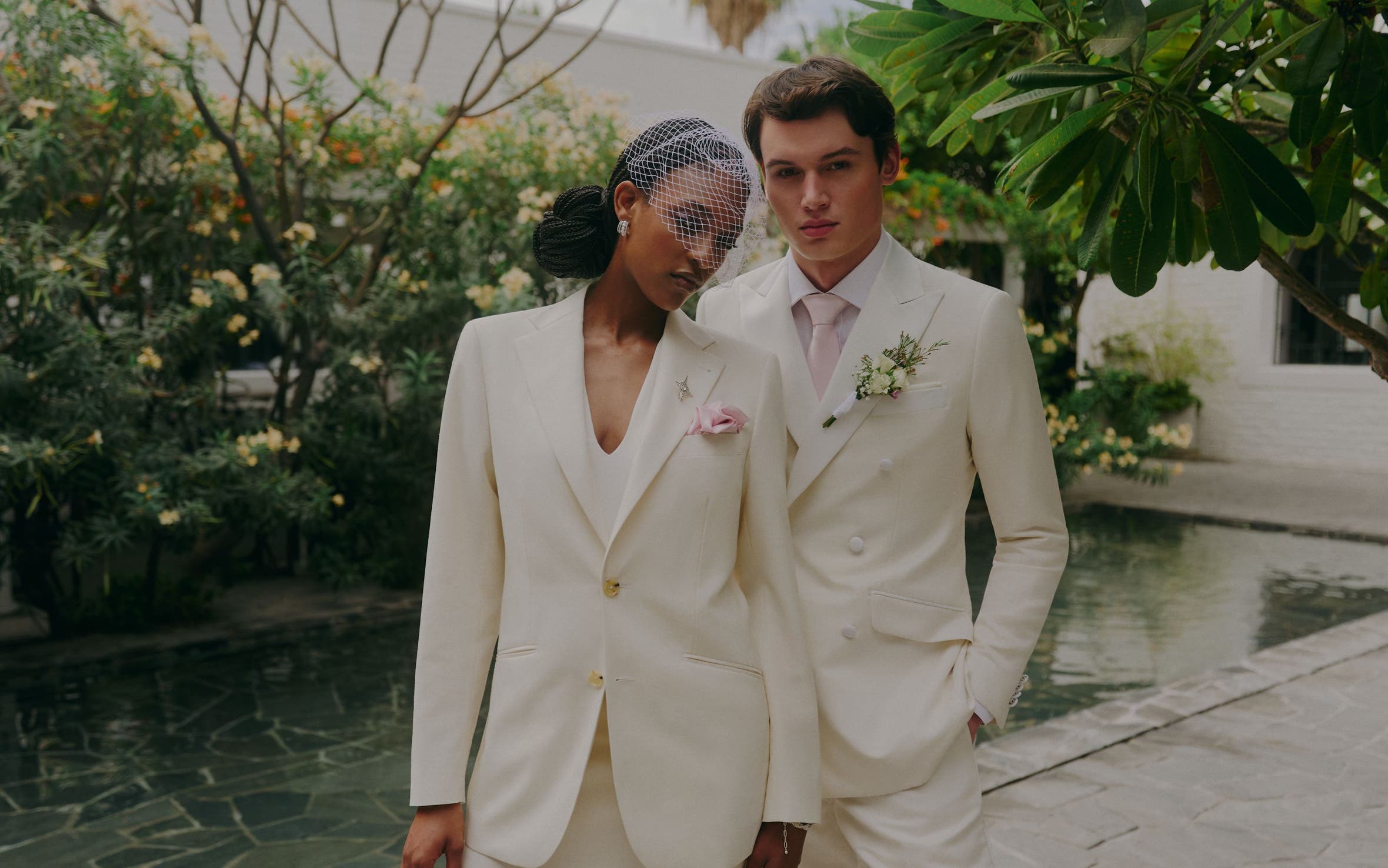 A woman and man wearing white suits. 