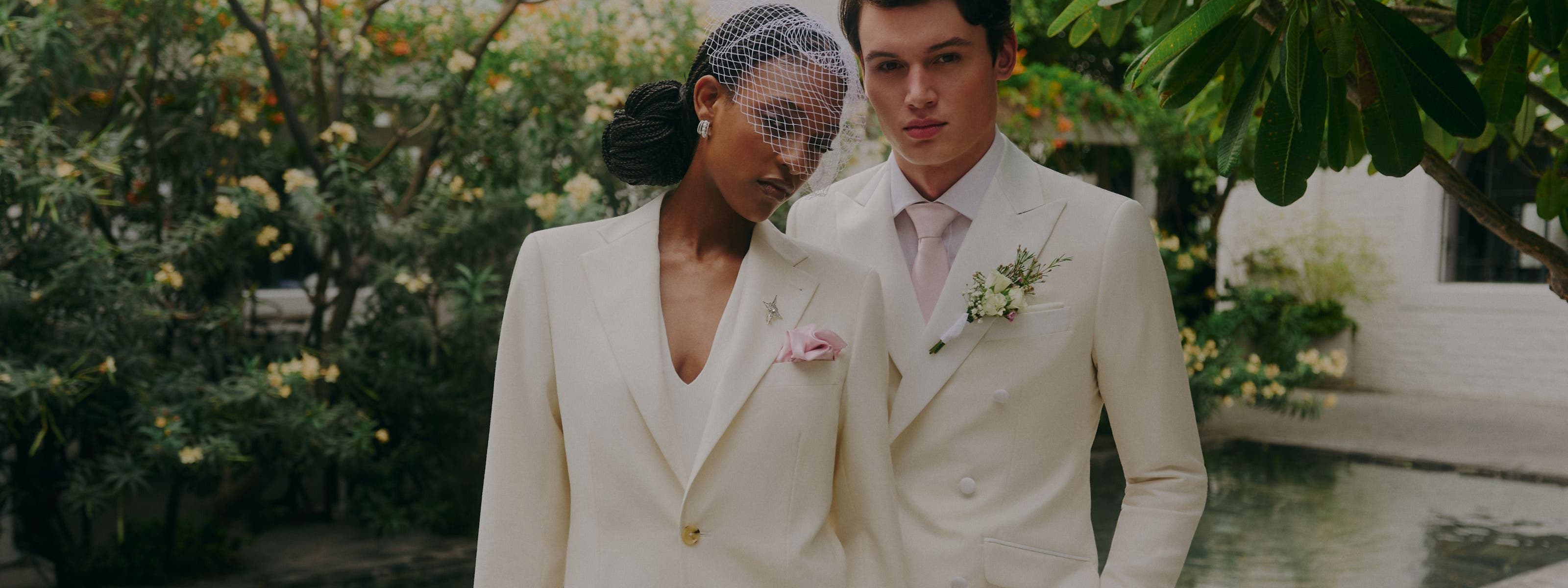 A woman and man wearing white suits.