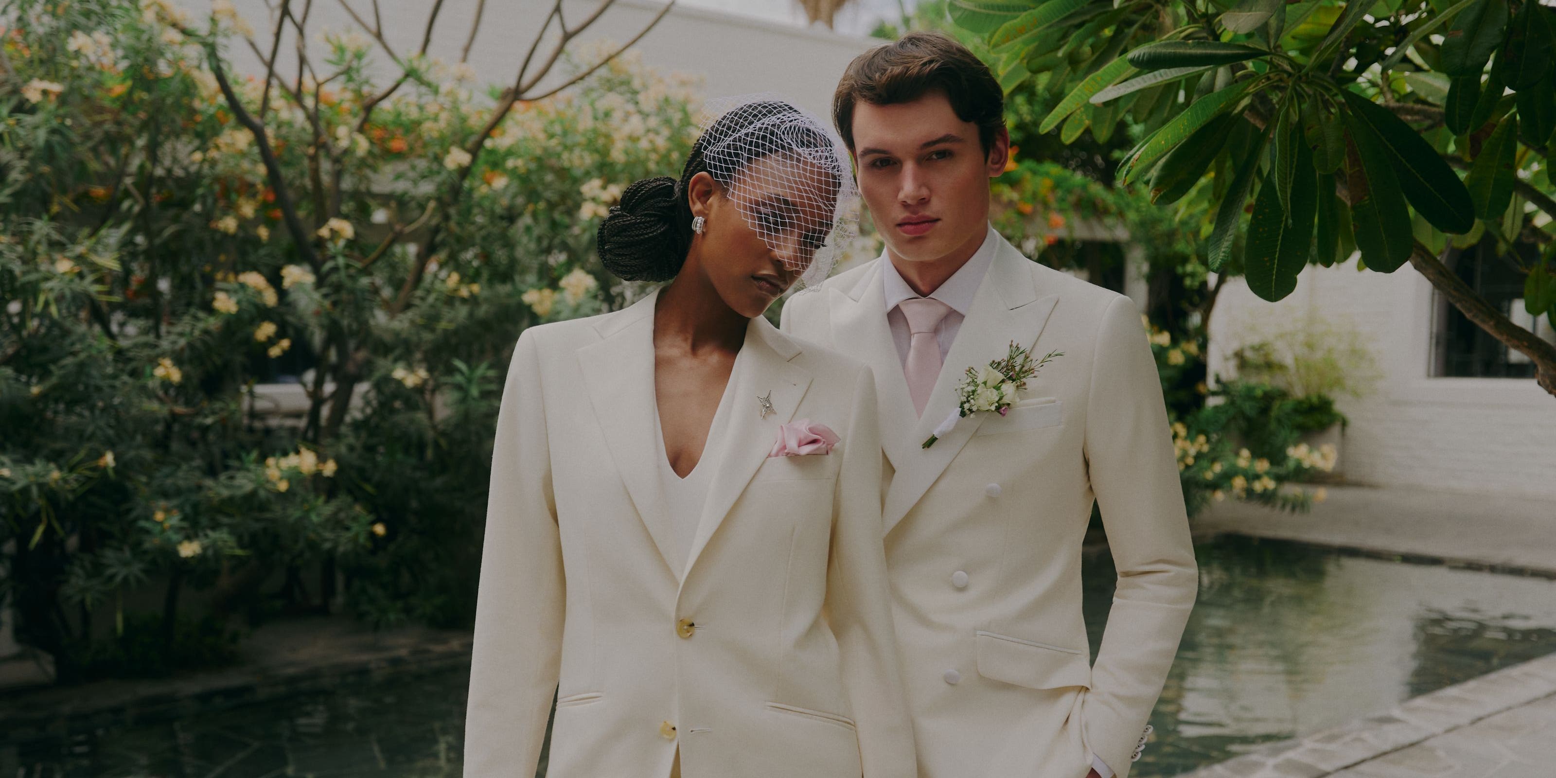 A woman and man wearing white suits.