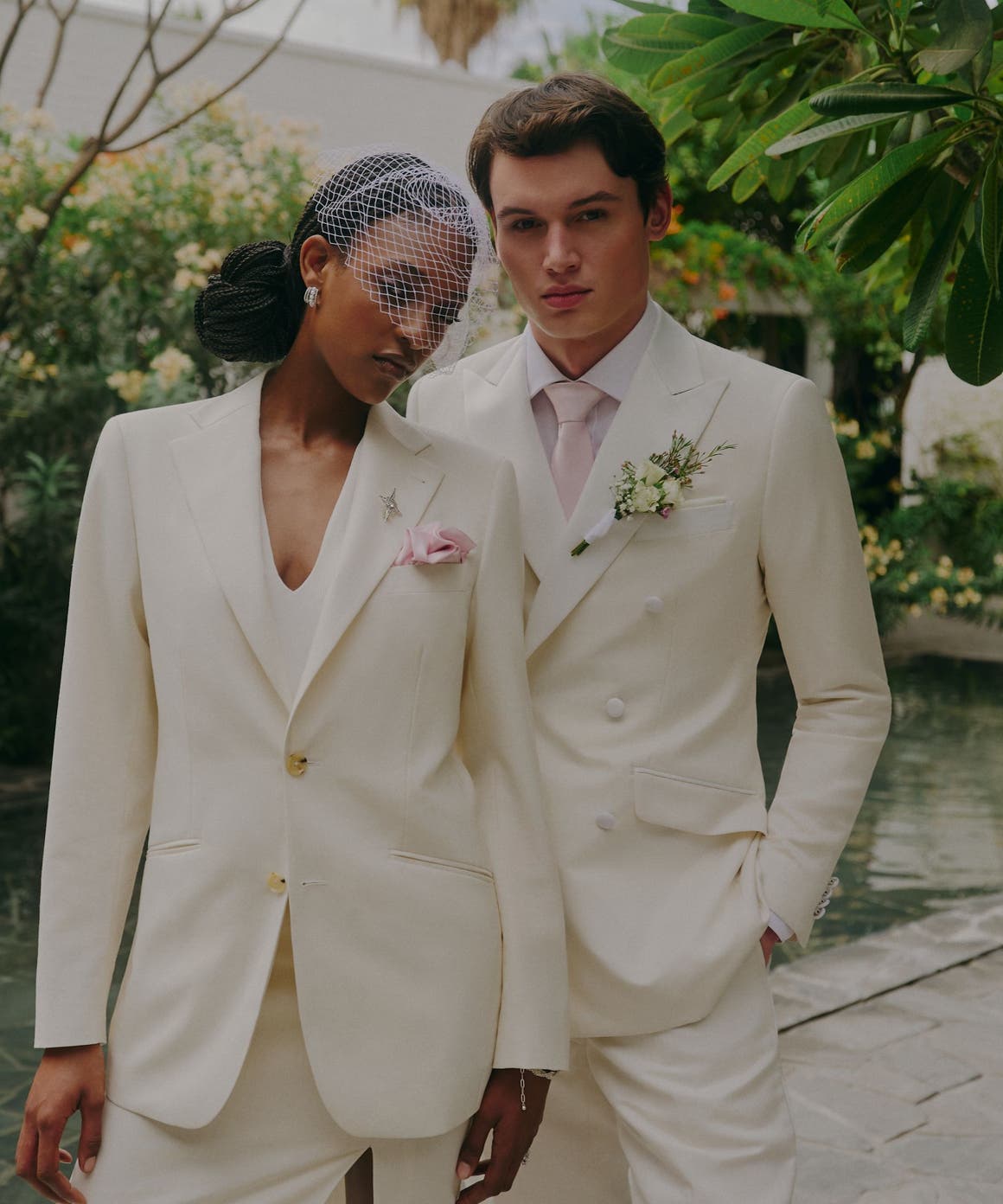 A woman and man wearing white suits.