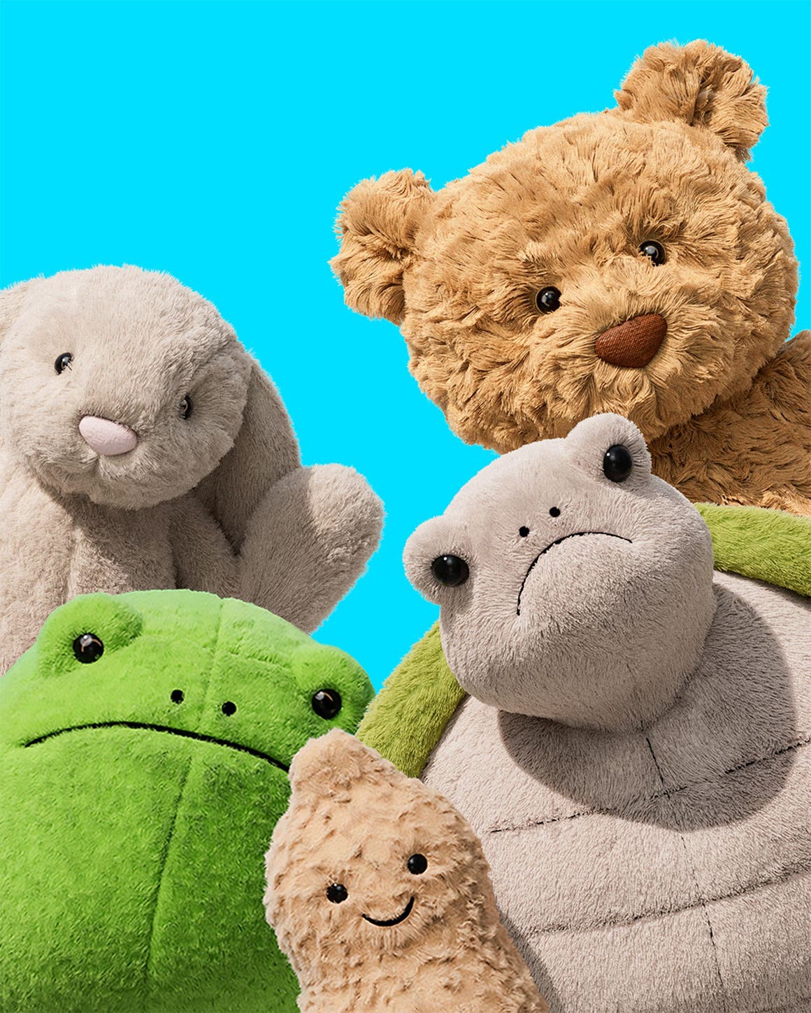 Assorted Jellycats facing the camera; a bunny, bear, peanut, frog and turtle.
