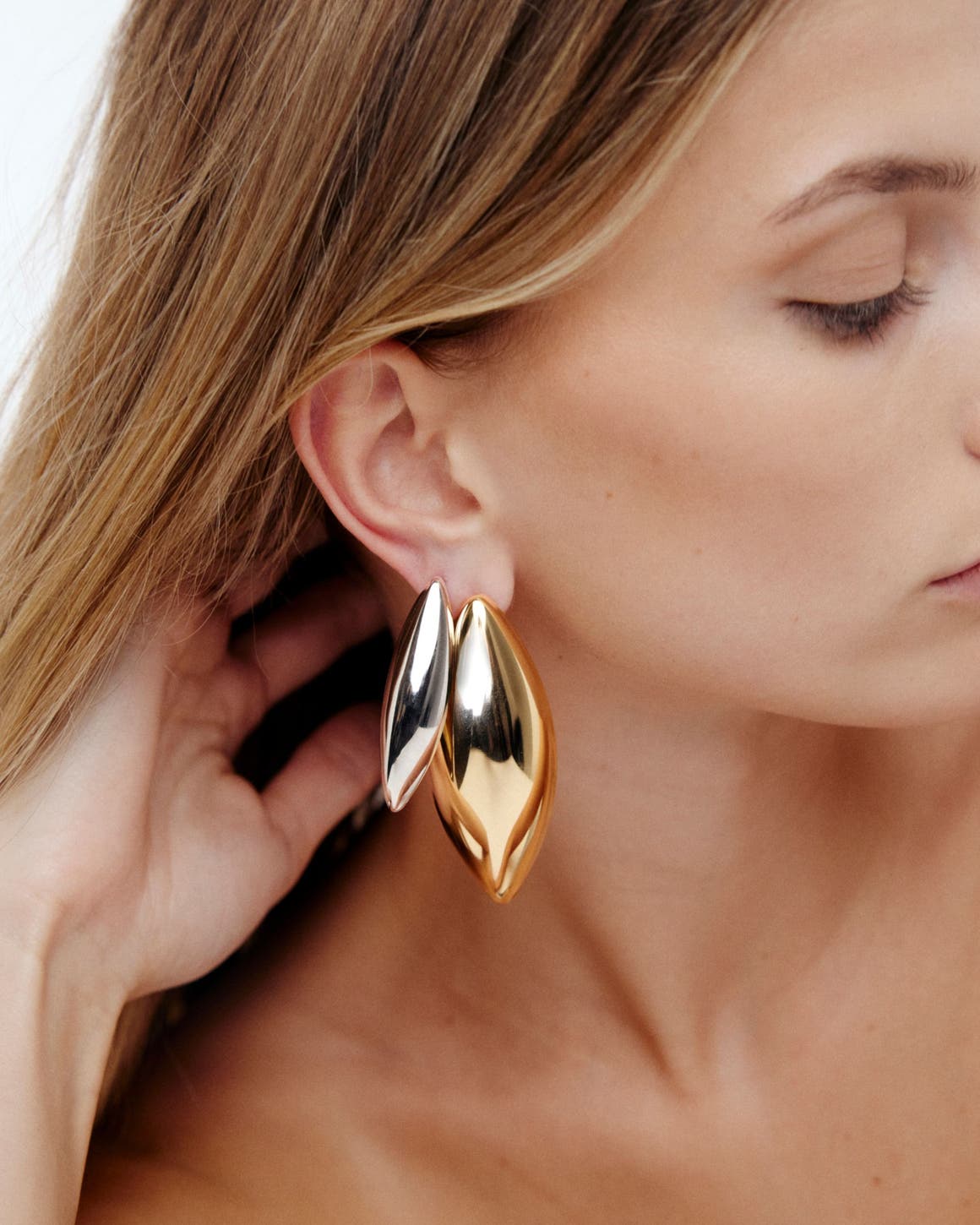 A woman wearing earrings.