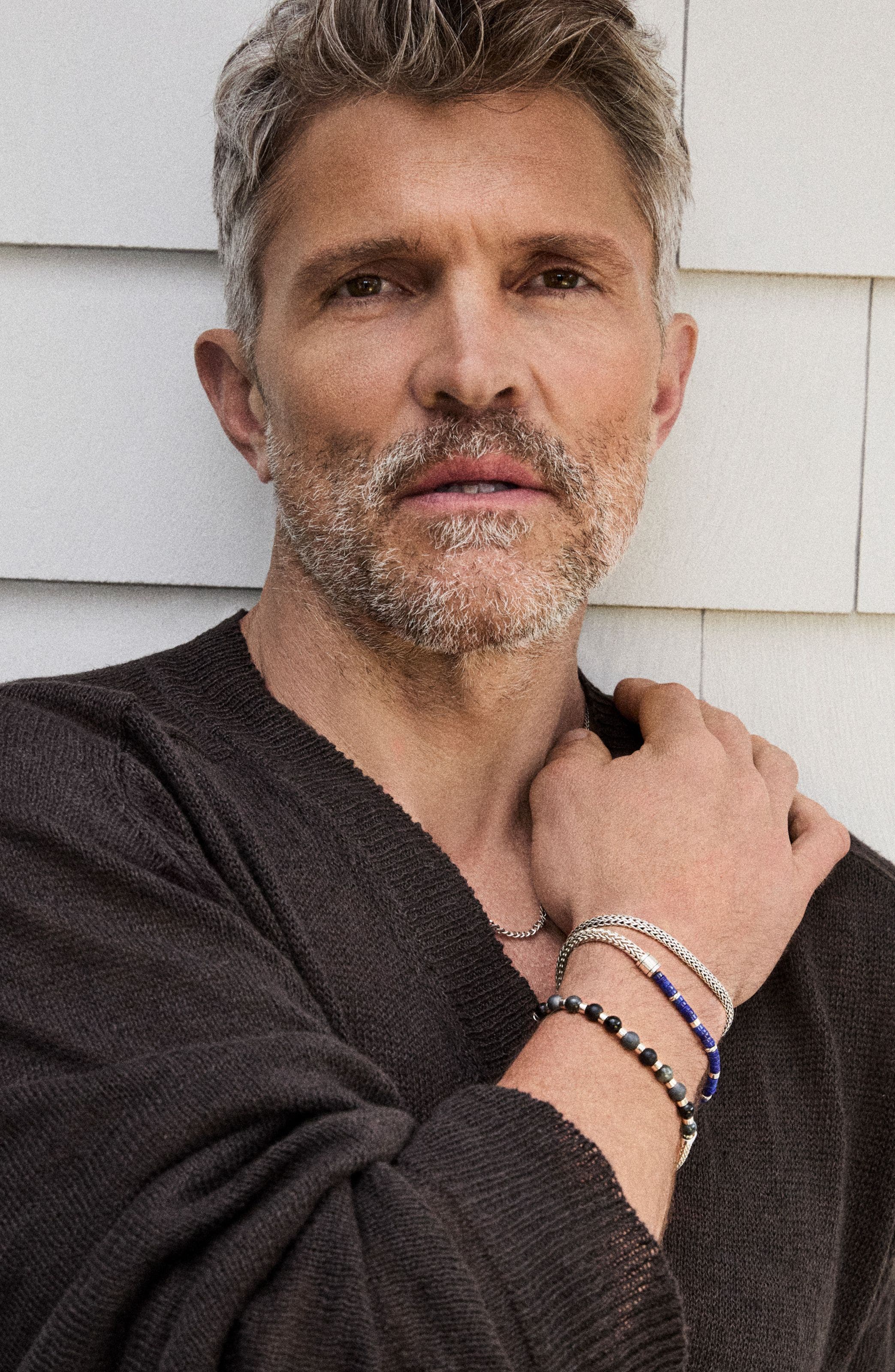 A man wearing several bracelets.