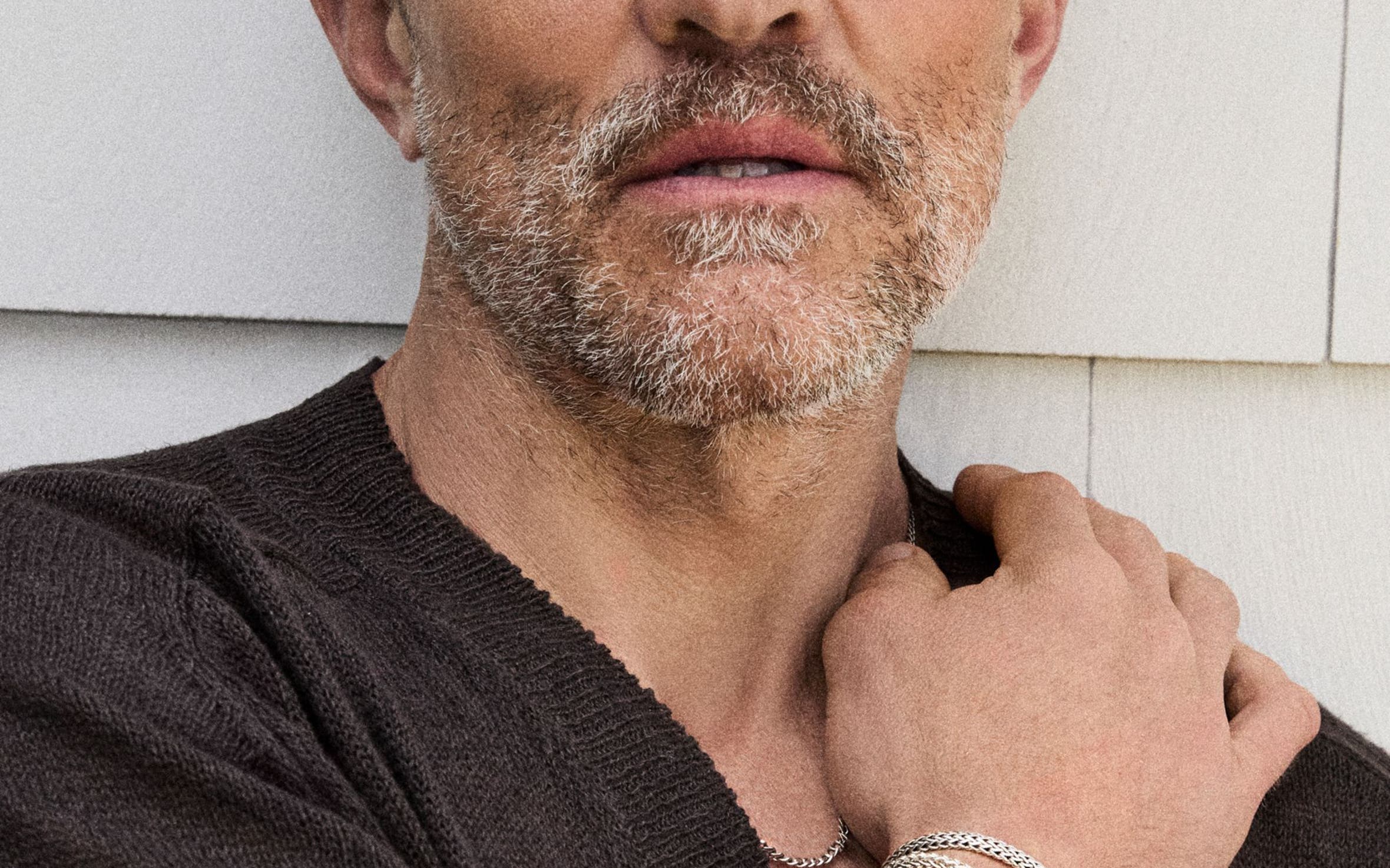 A man wearing several bracelets.