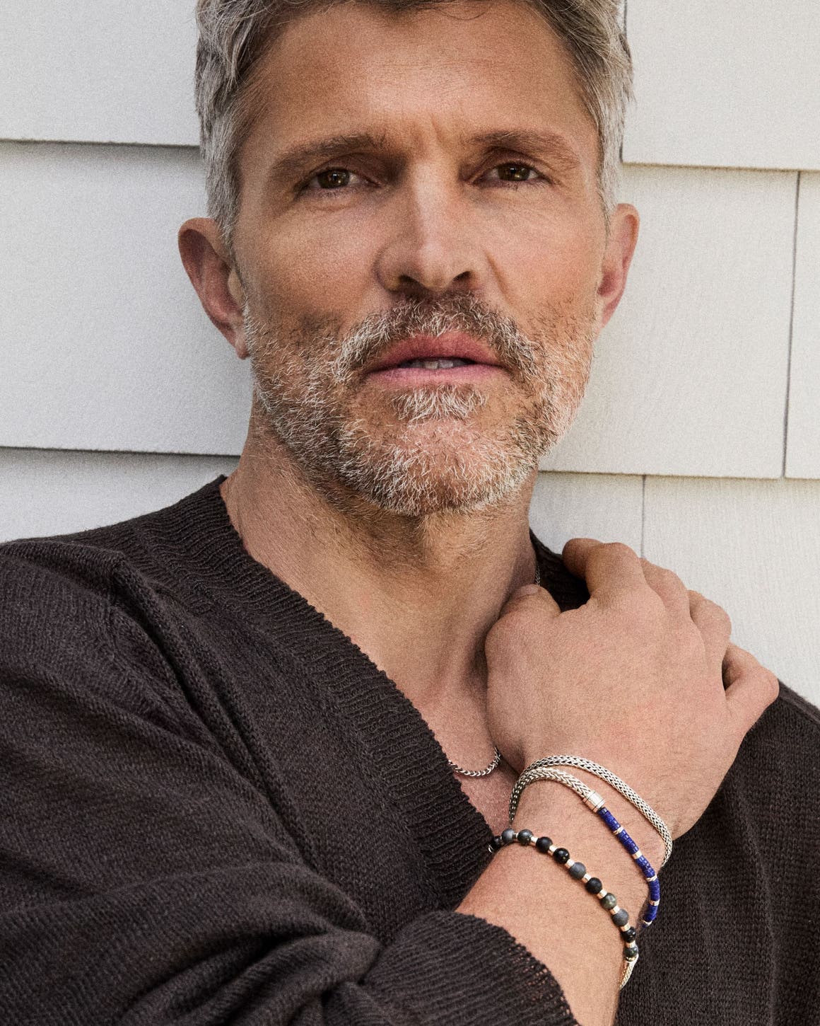 A man wearing several bracelets.