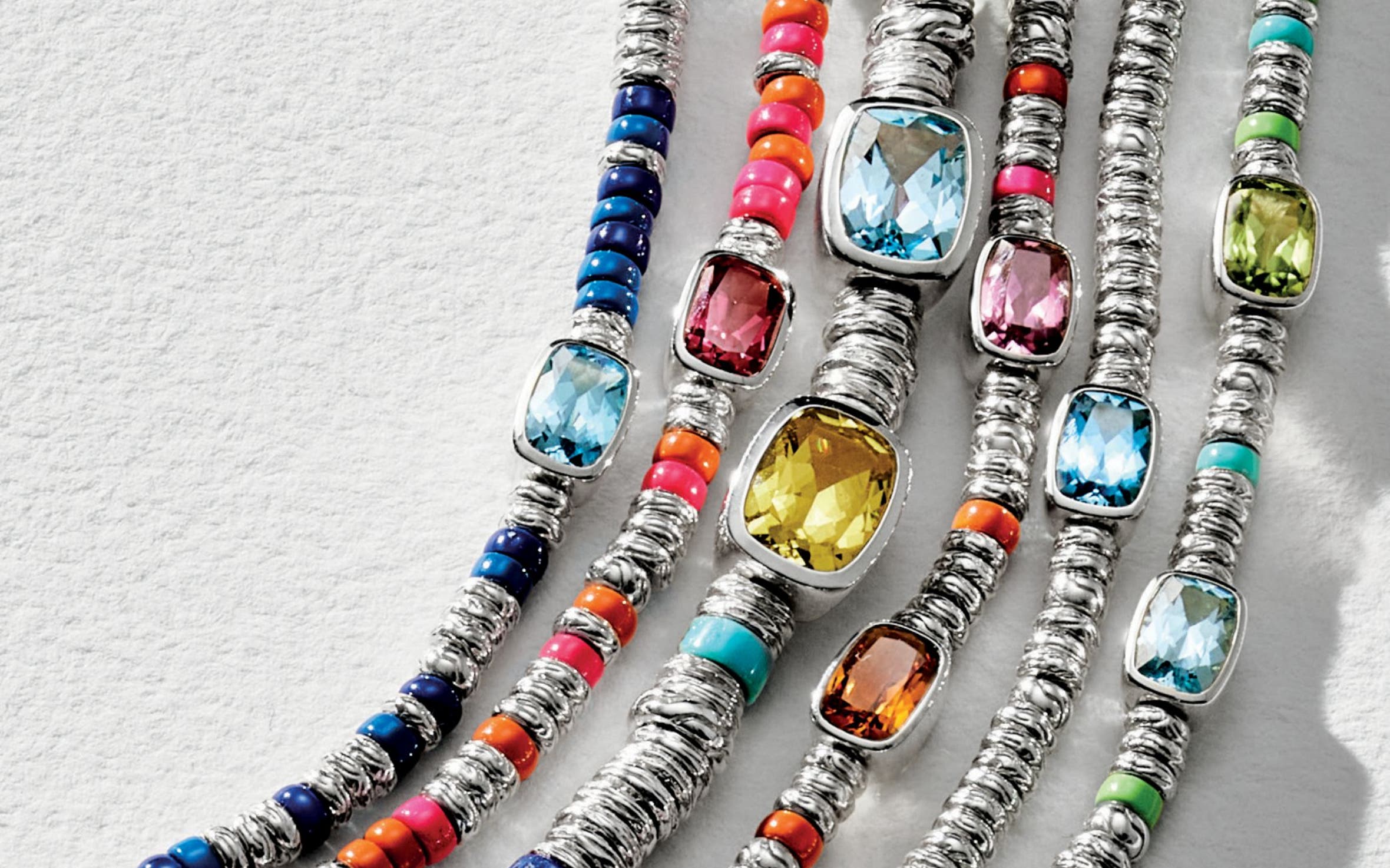 A selection of colorful gemstone necklaces and bracelets.