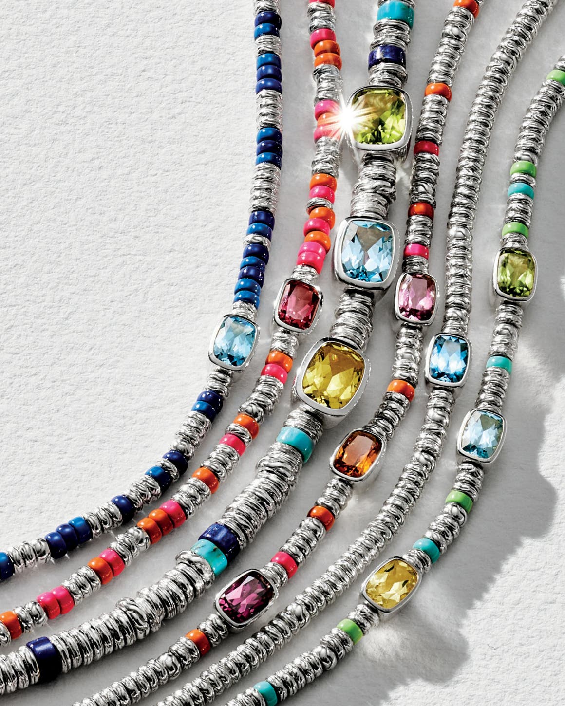 A selection of colorful gemstone necklaces and bracelets.