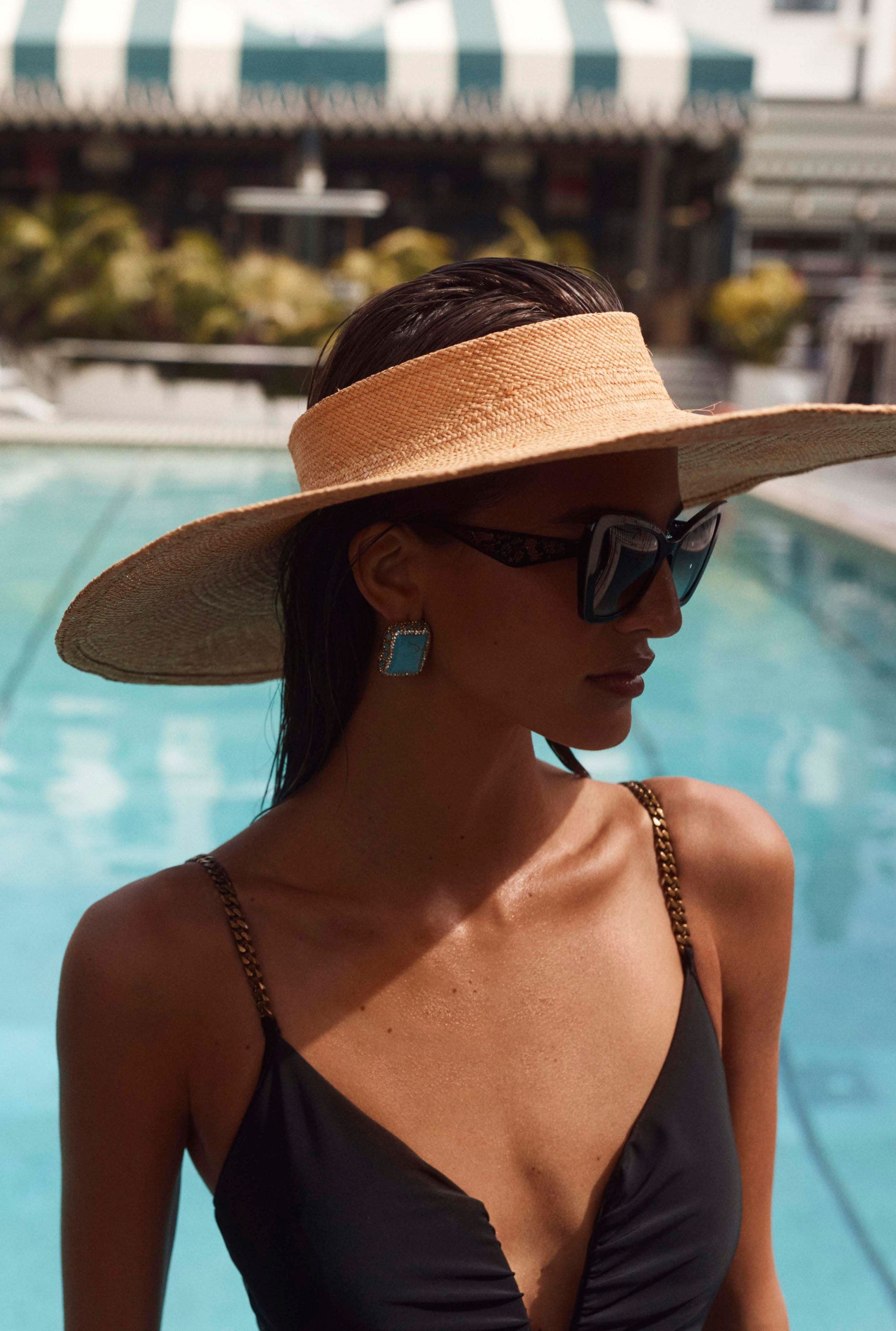 A woman wearing a wide-brim hat.