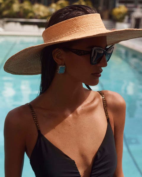 A woman wearing a wide-brim hat.