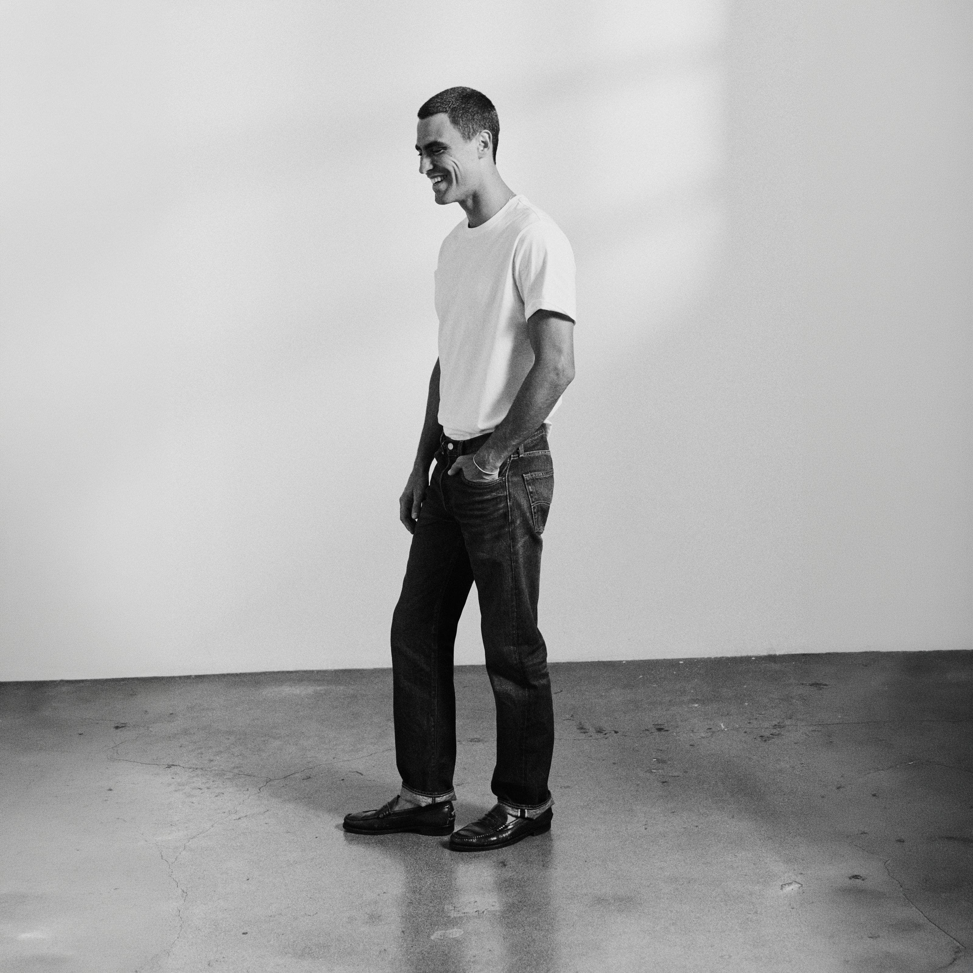 A man in white tee wearing Levi's.