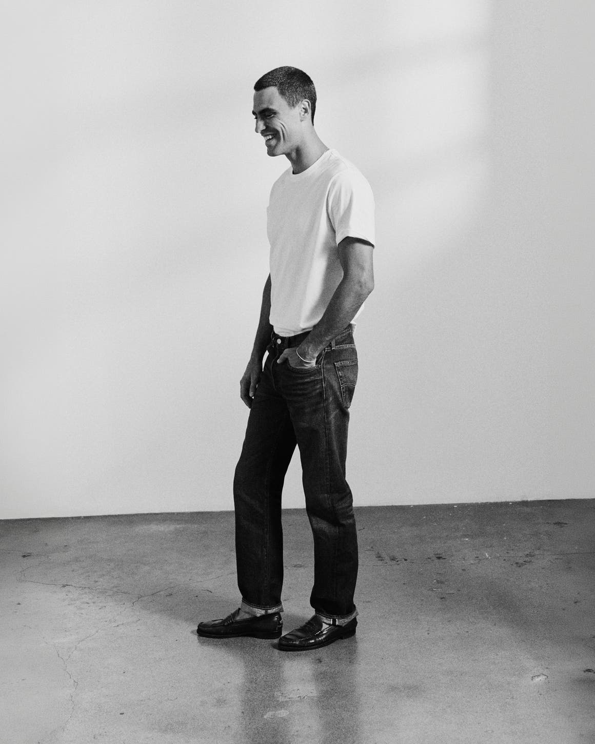A man in white tee wearing Levi's.
