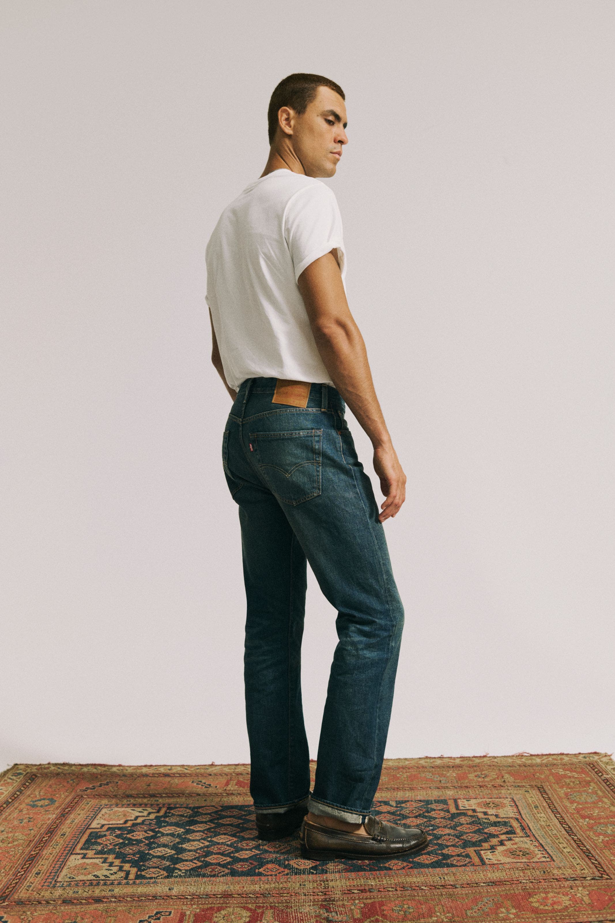 A man in white tee wearing Levi's.