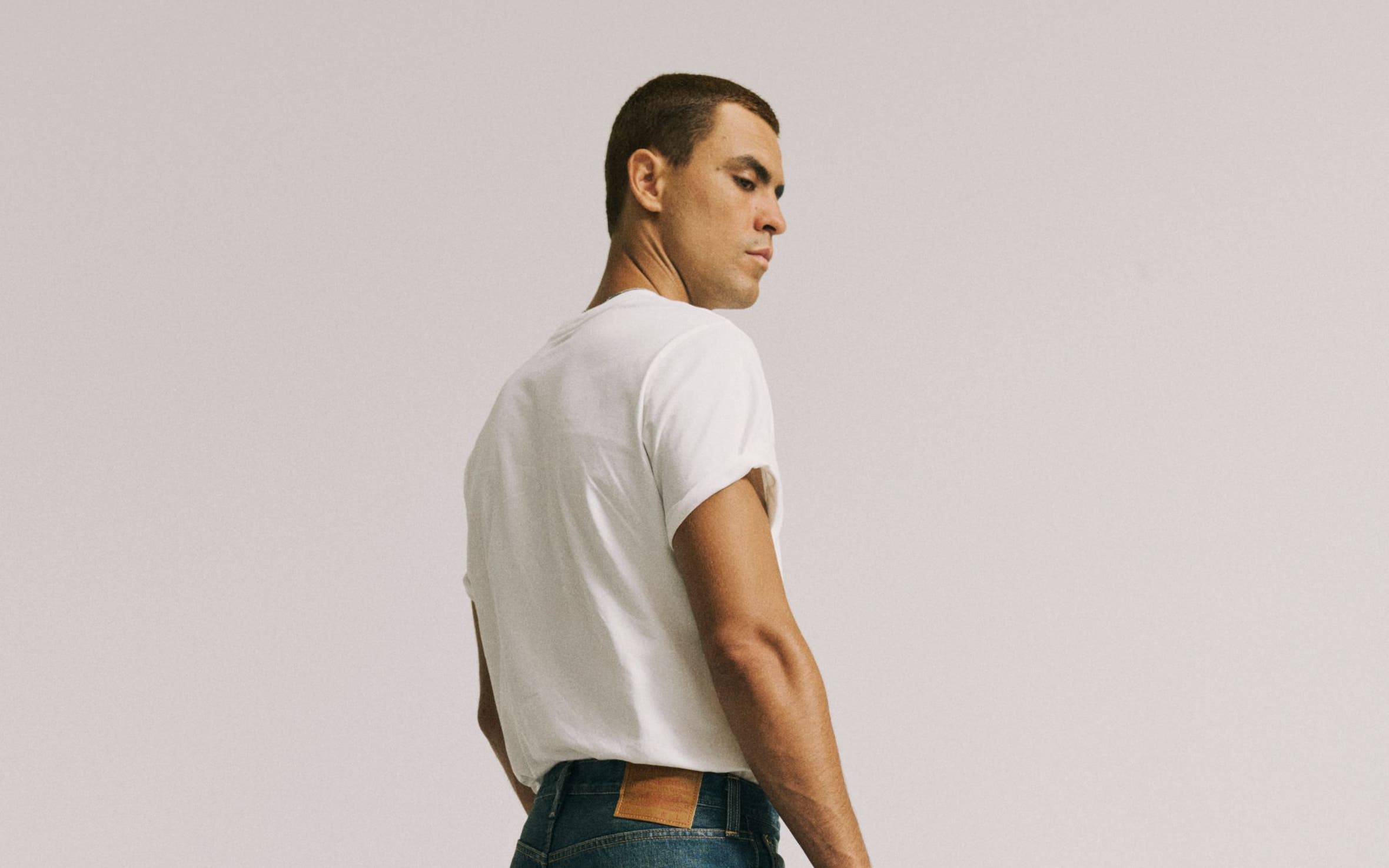 A man in white tee wearing Levi's.
