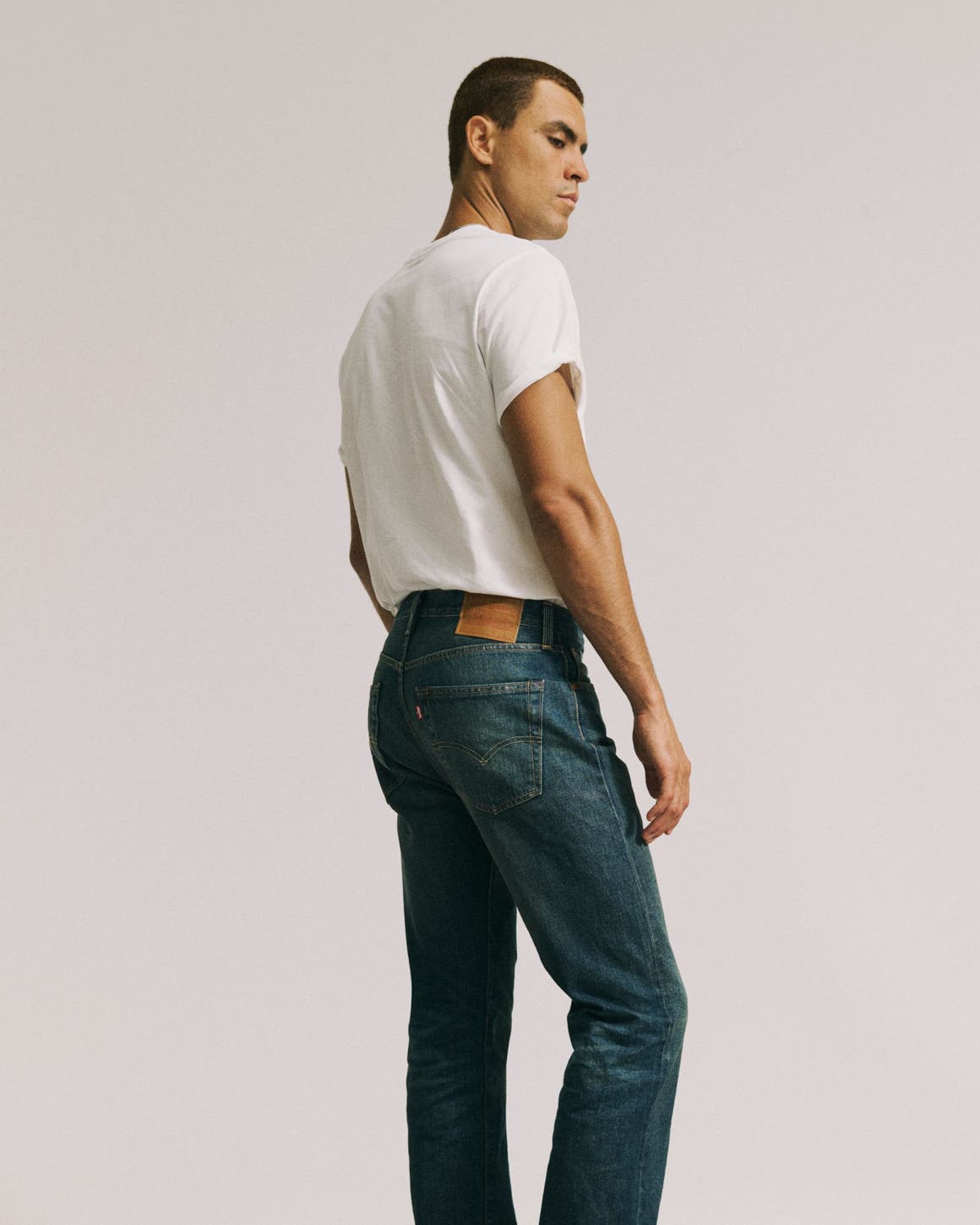 A man in white tee wearing Levi's.