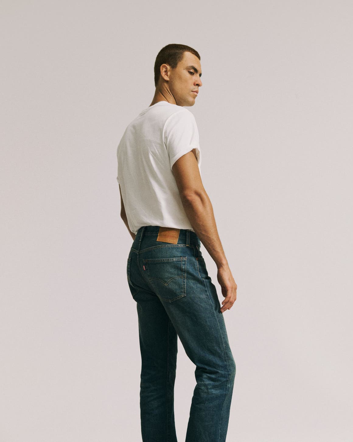 A man in white tee wearing Levi's.