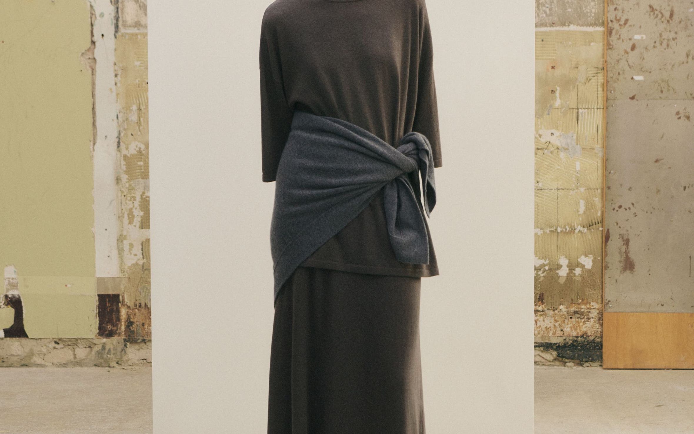 Woman in head to toe grey look.