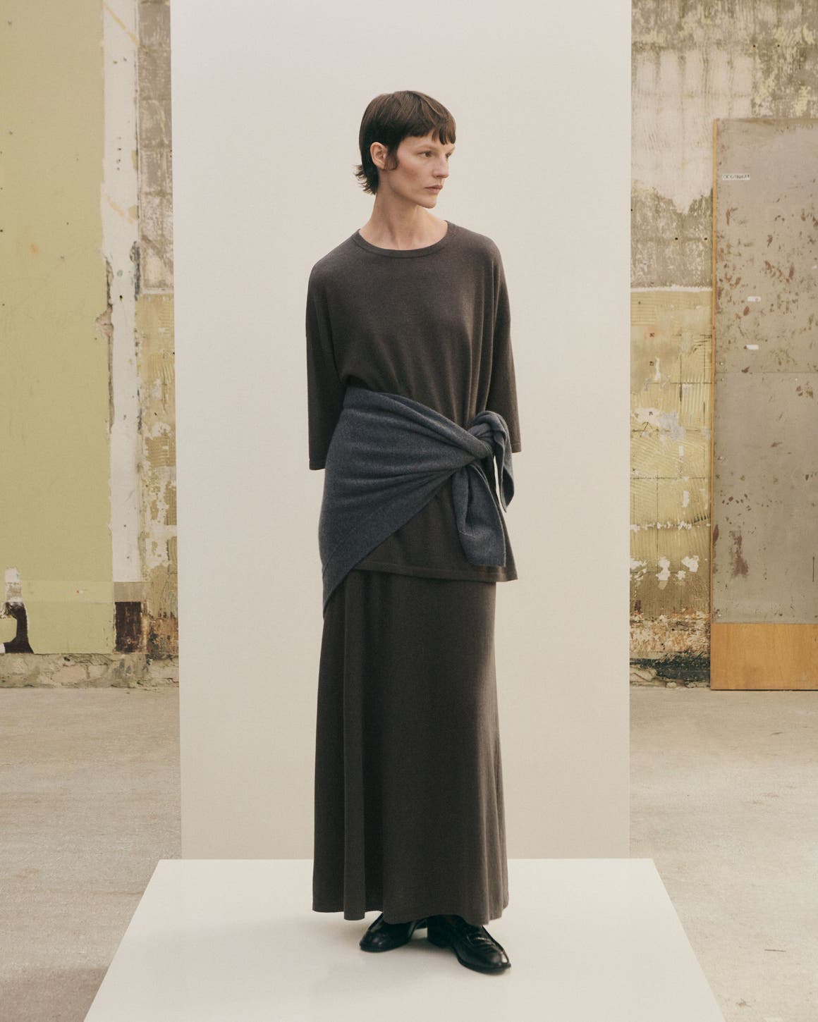 Woman in head to toe grey look.