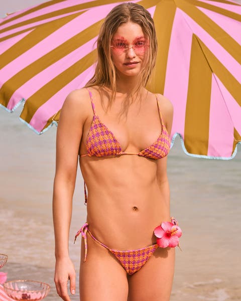 A woman wearing a smocked check bikini.