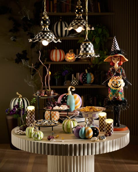 A table with Mackenzie Childs Halloween decor.