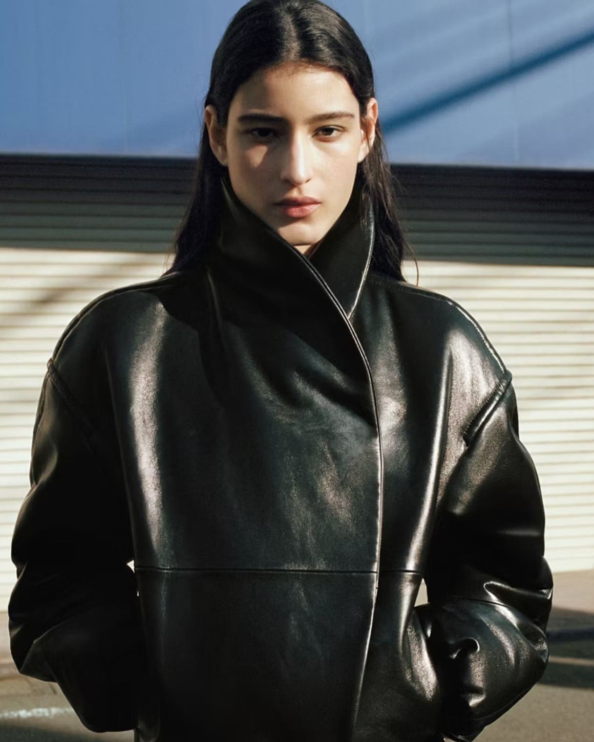 Woman wearing black leather MANGO jacket.