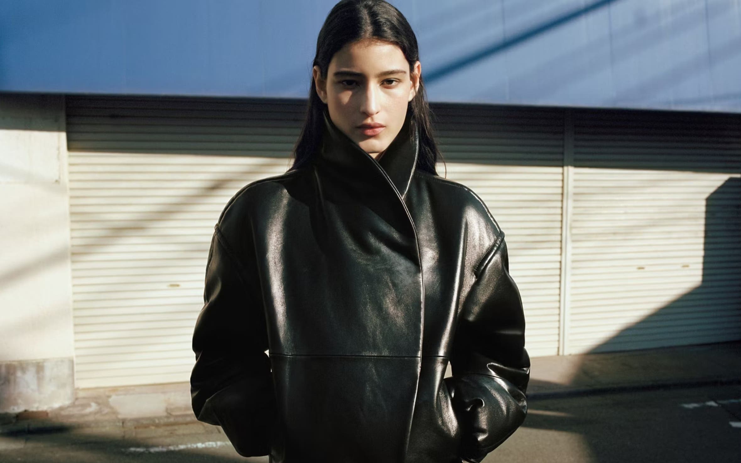 Woman wearing black leather MANGO jacket.