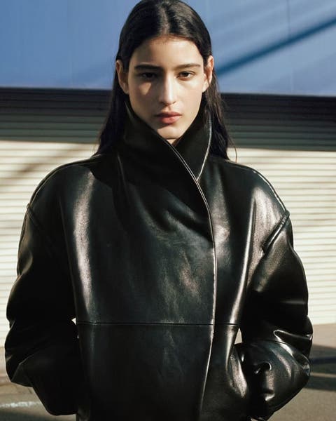 Woman wearing black leather MANGO jacket.