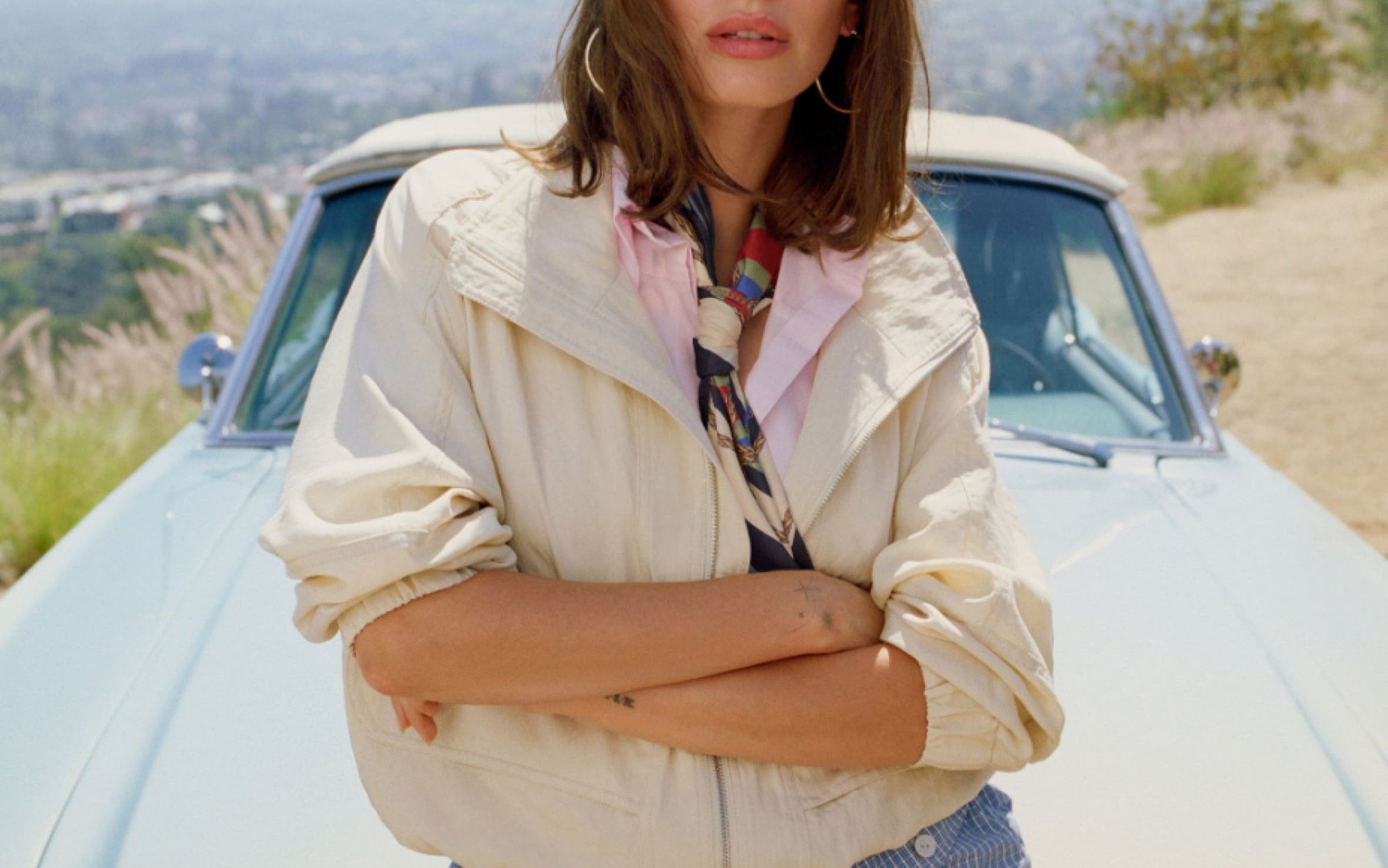 Hailey Bieber wearing bubble shorts and a bomber jacket.