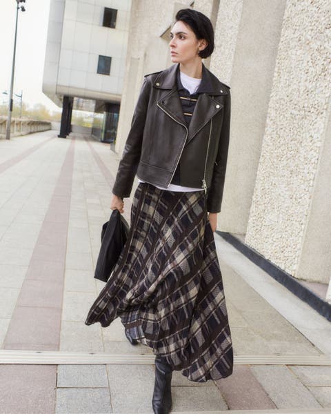 Model wearing plaid Mango skirt and leather jacket.