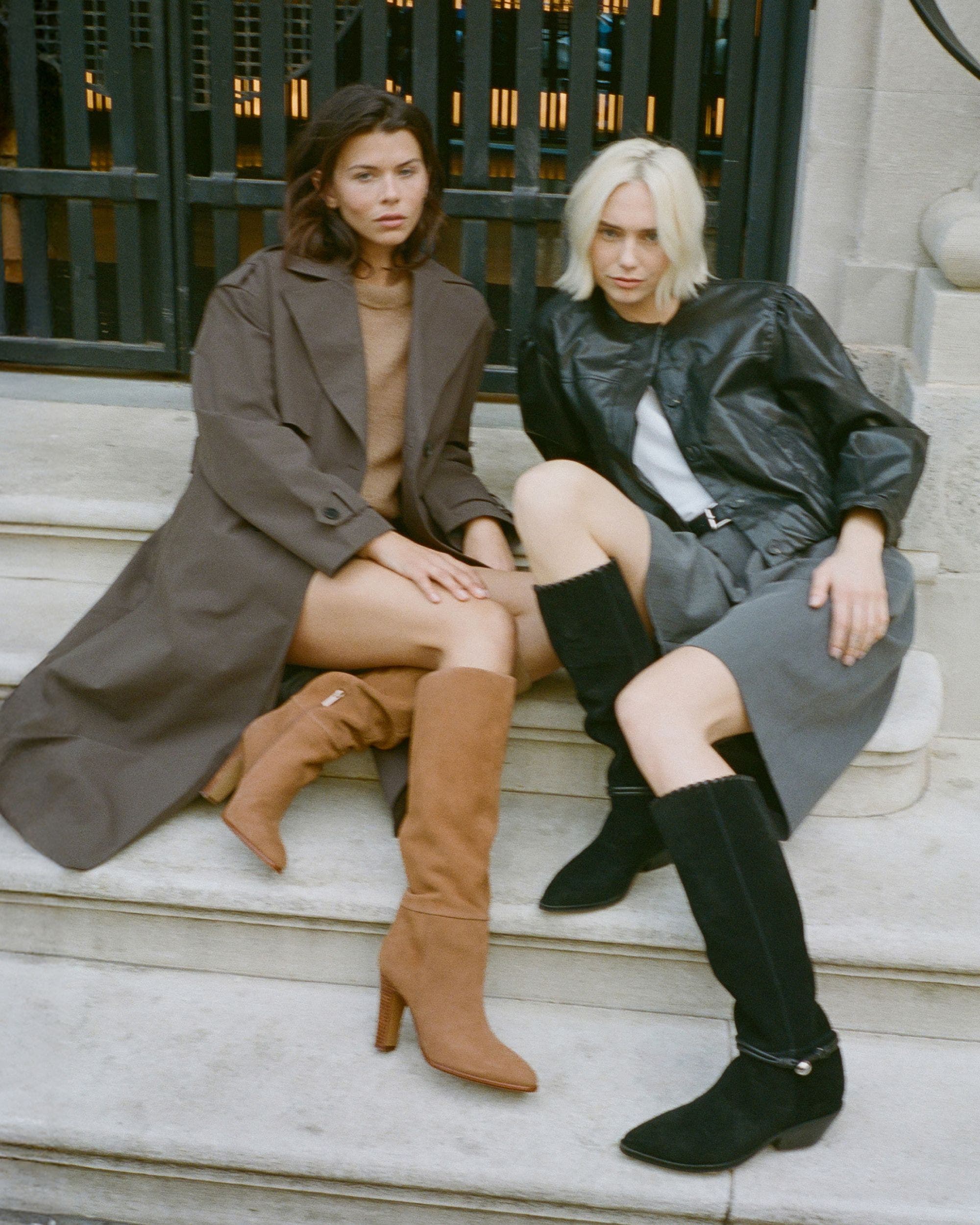 Two girls sitting on the stairs in brown and black suede knee high boots