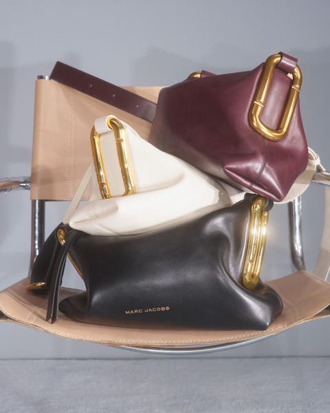 3 Marc Jacobs bags stacked on top of each other.