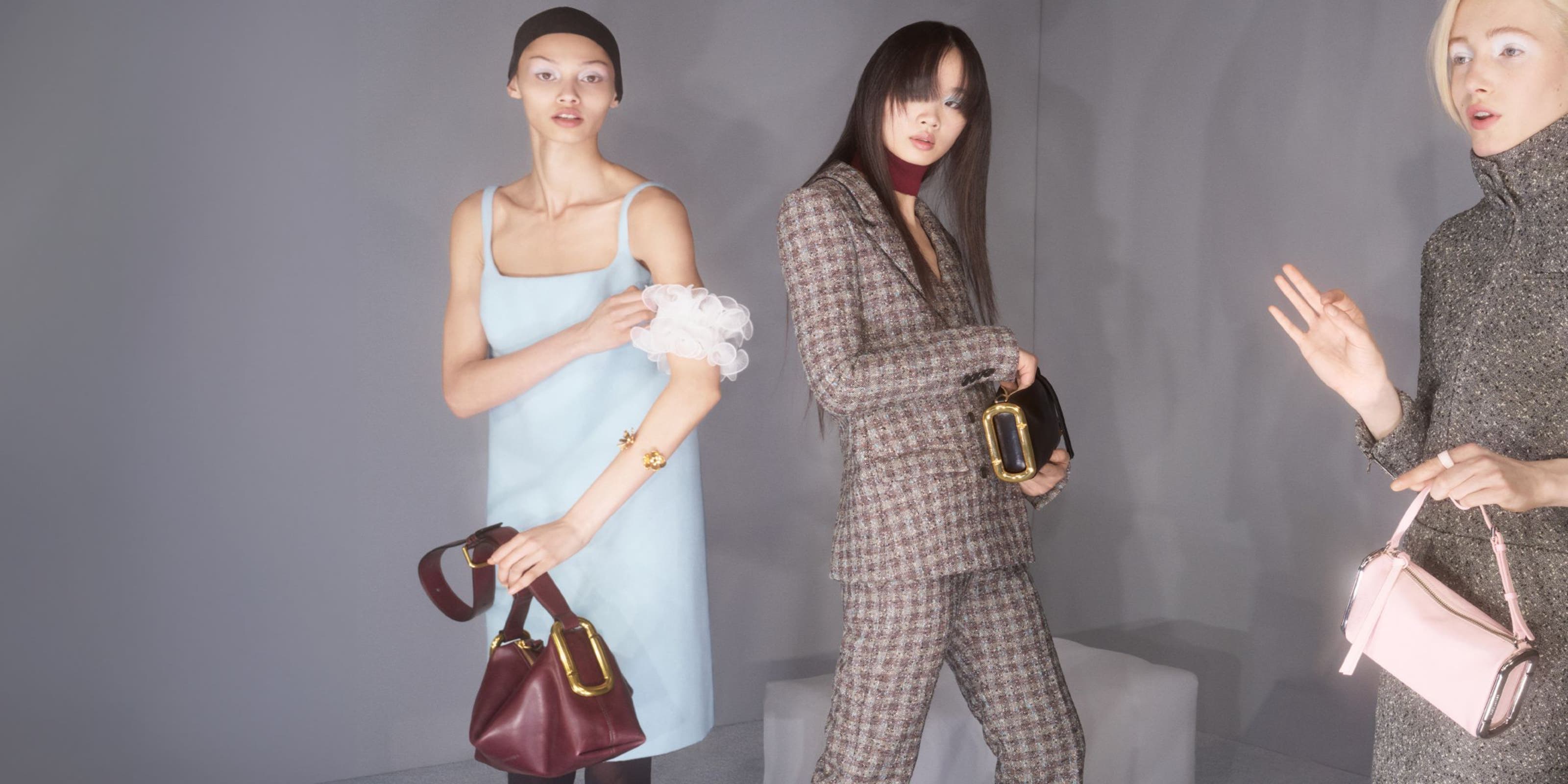 3 Woman holding a Marc Jacobs bag.