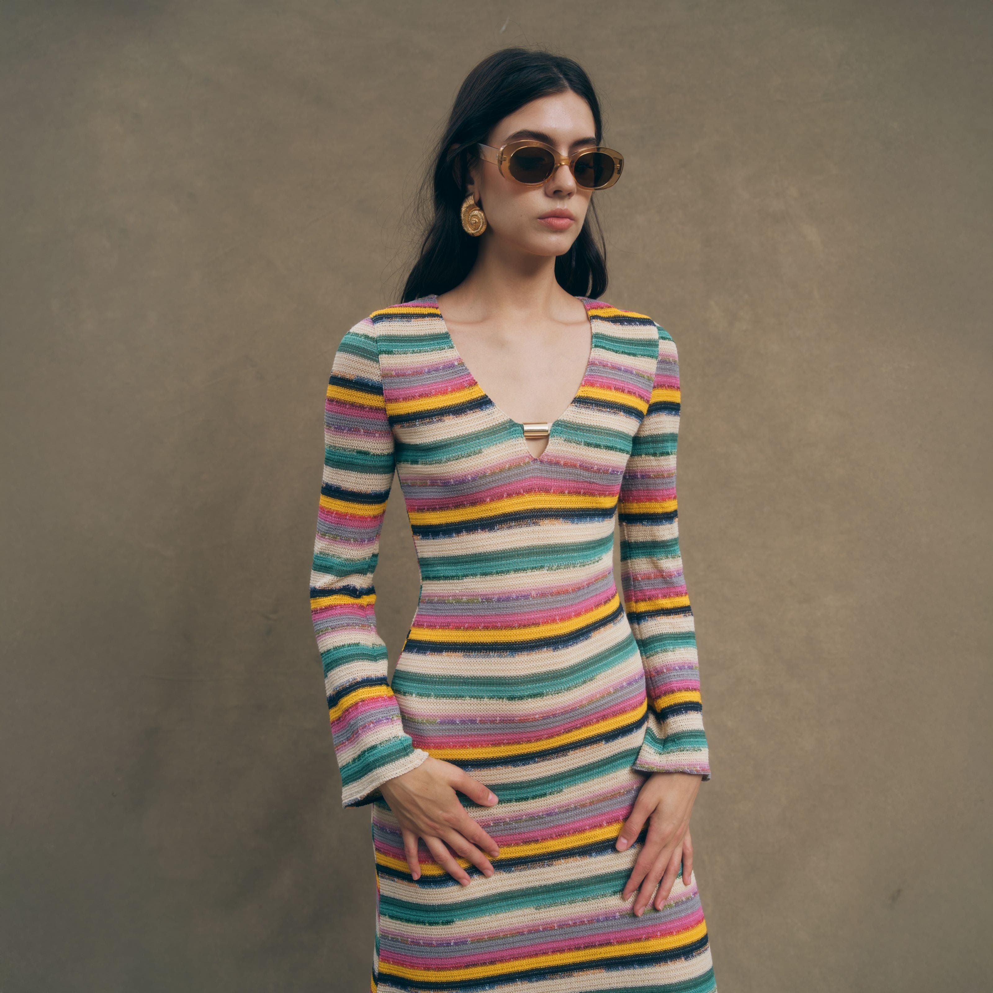 A woman wearing a striped long-sleeved dress.