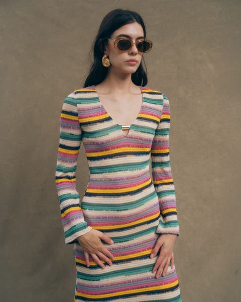 A woman wearing a striped long-sleeved dress.