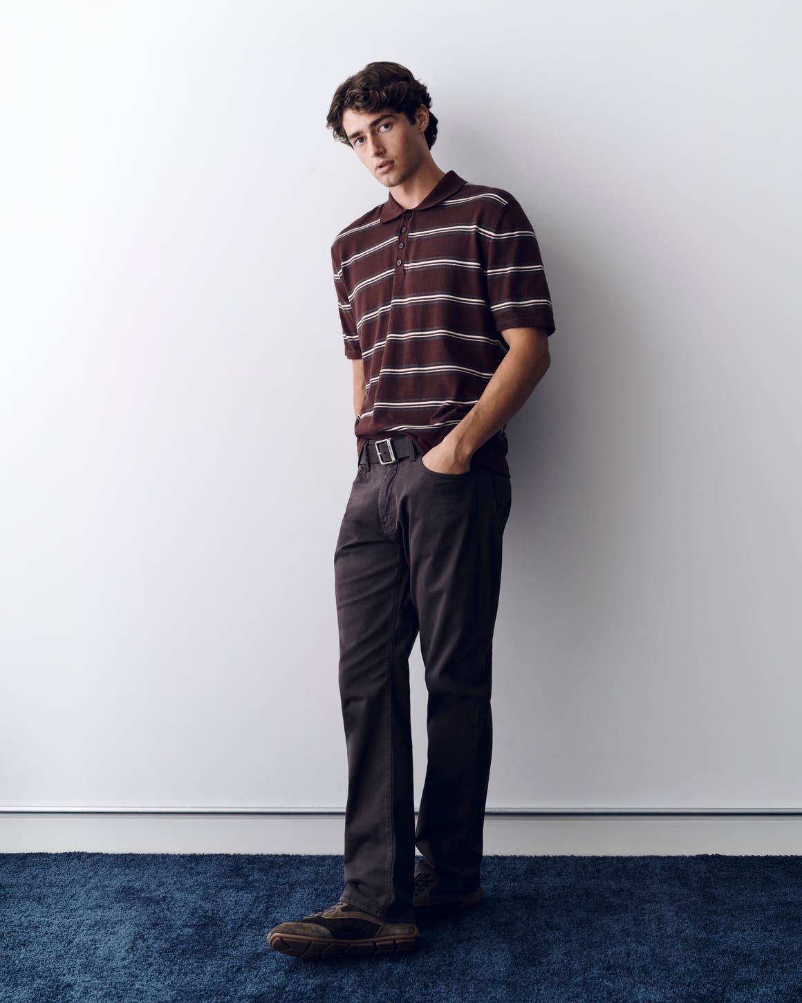 Man in Mavi Jeans and a striped polo.